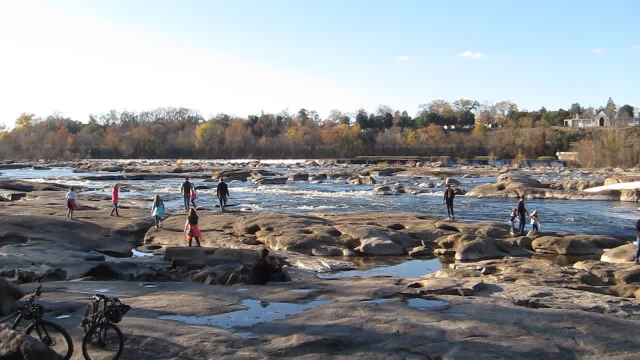 People playing on the rocks around Belle Isle